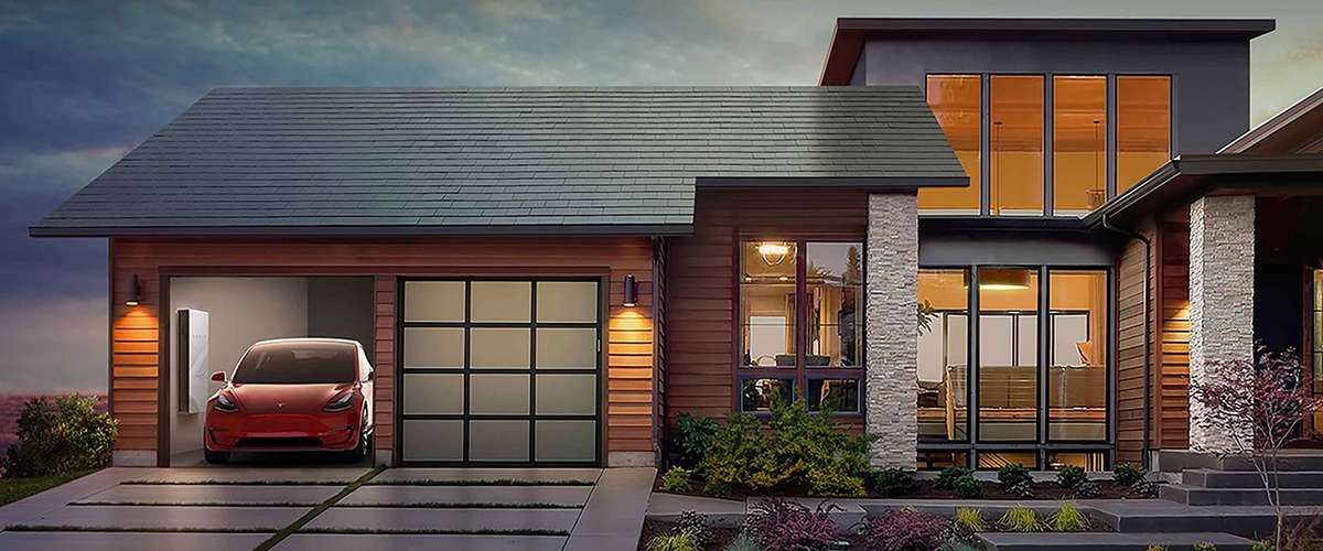 Tesla Roof Modern house with a sleek design, large windows, and wood paneling. A red electric car is parked in the garage.